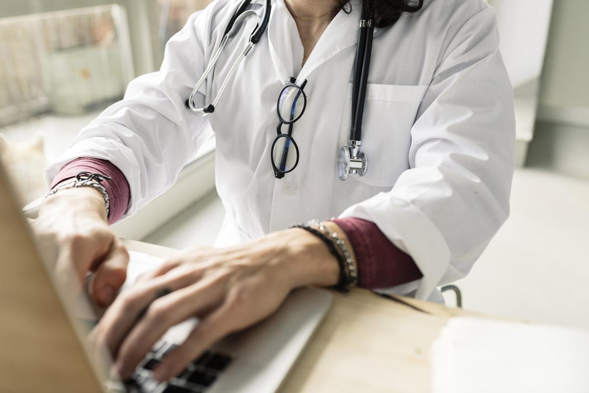 Doctor works at a laptop