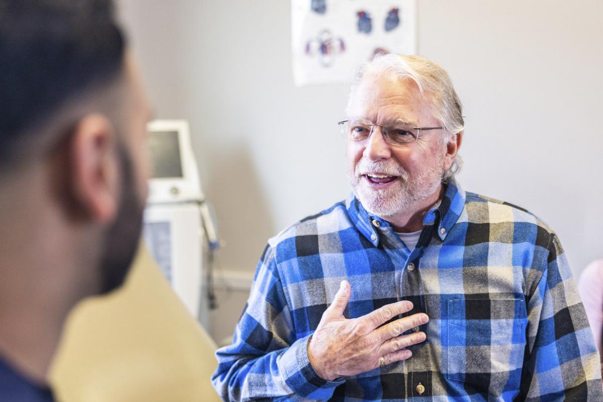 Patient with a hand to chest