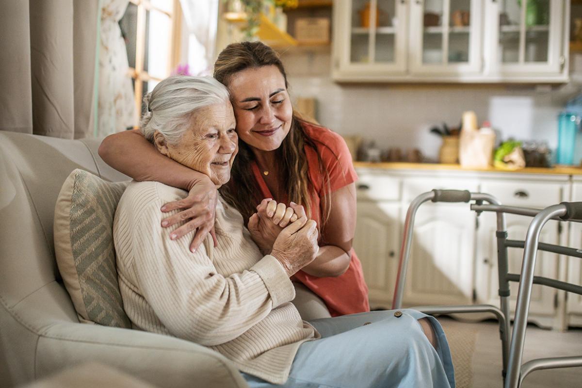 Smiling woman embraces another