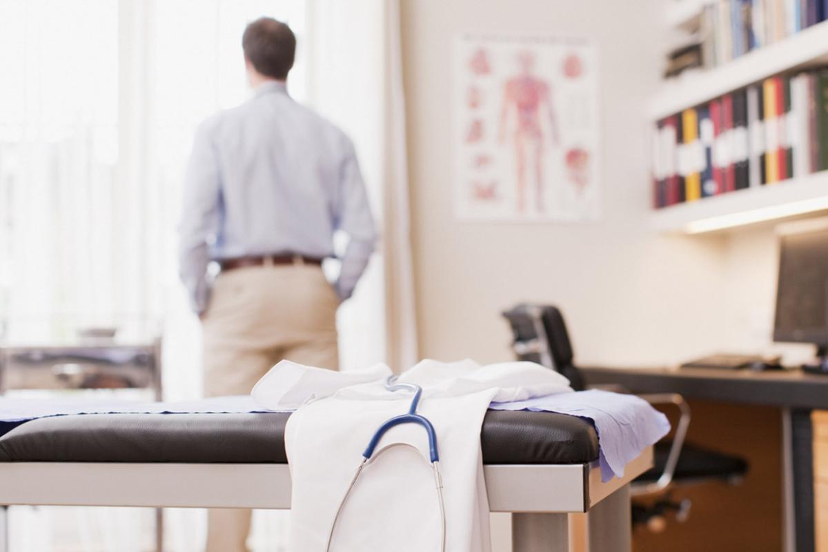 Physician looks out a window