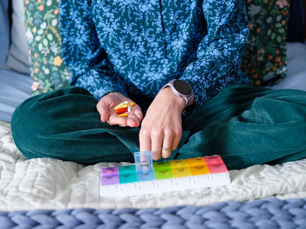 Vogel sorts her daily medications and supplements