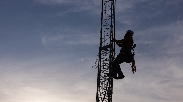Man climbing an eddy covariance tower.