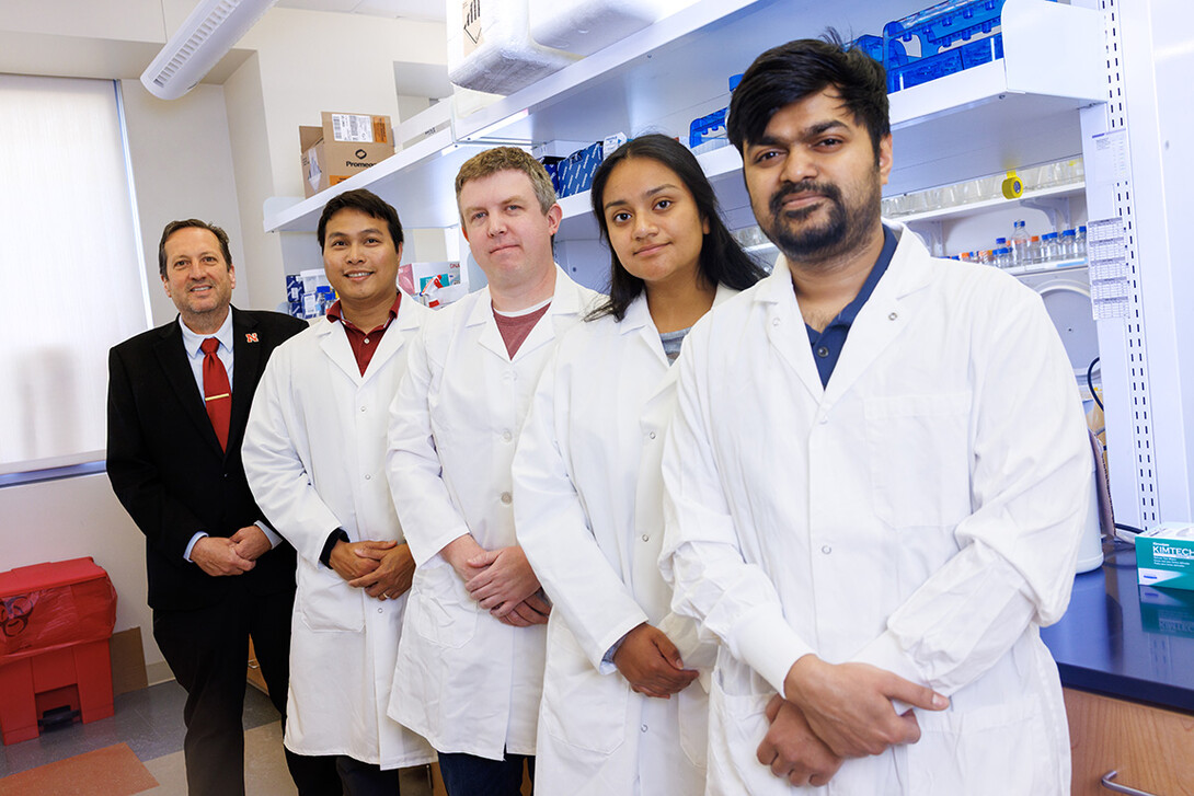 Eric Weaver, professor of biological sciences and director of the Nebraska Center for Virology, from left, stands alongside Adthakorn Madapong, Joshua Wiggins, Jennifer Gamez Martinez, and Zahidul Islam inside his lab at the Morrison Life Sciences Center.
