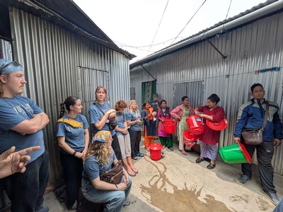 People talking about water filters in a neighborhood in Nepal.