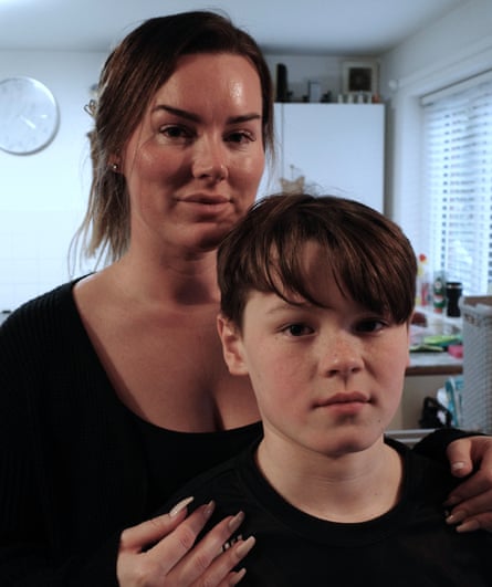 Mother Shauna stands behind son Mason, her hands on his shoulders.