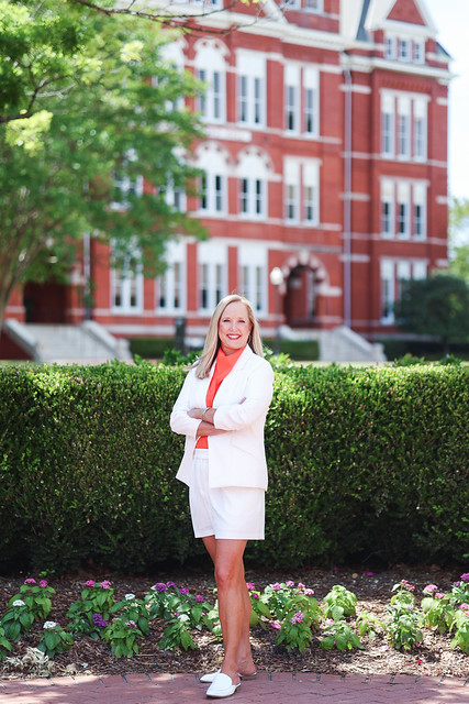 Ashley Powell is pictured outdoors standing in front of Auburn University's Samford Hall.
