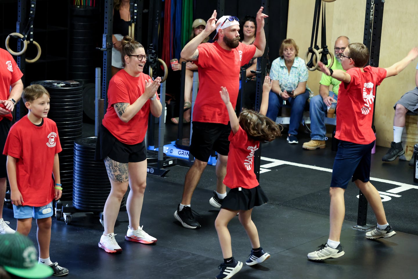 Coaches lead jumping jacks at the free functional fitness program.