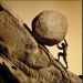 Sisyphus pushes the boulder up a hill