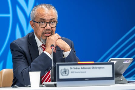 Tedros Adhanom Ghebreyesus sits at a desk in front of a microphone
