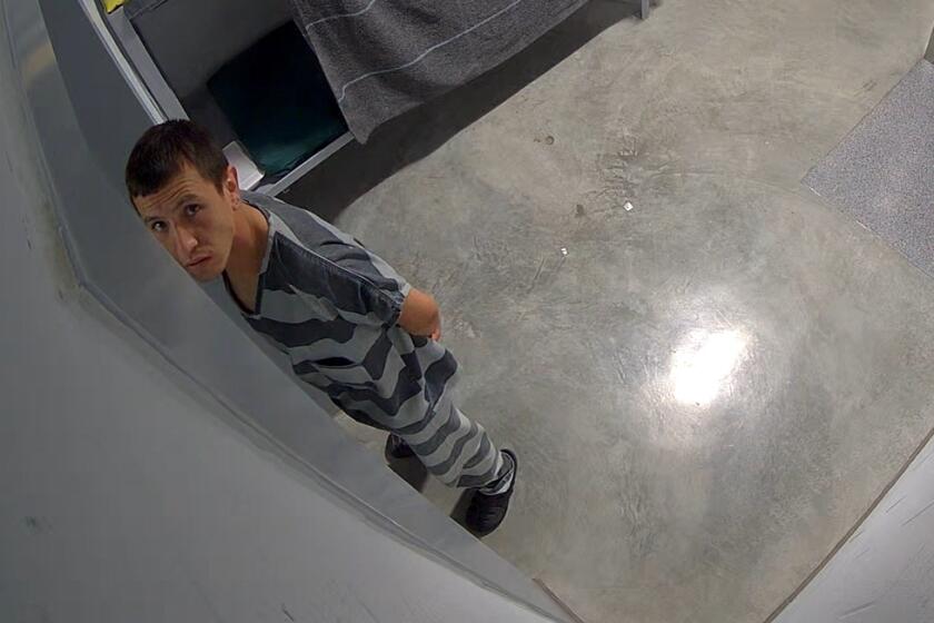 a man looks towards a surveillance camera