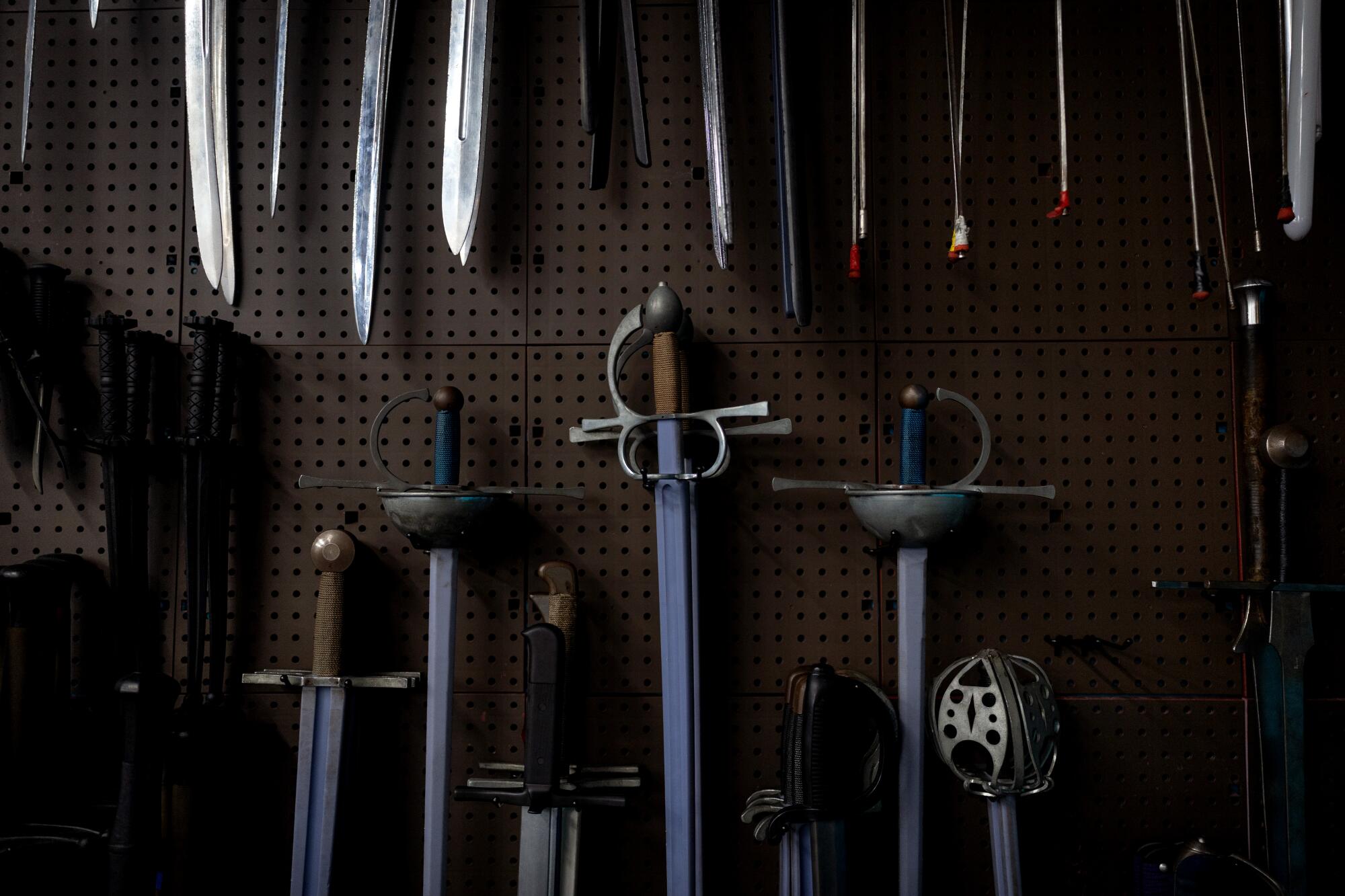 Swords are seen hanging on a wall at Swordplay LA.