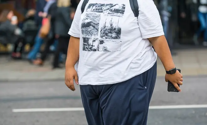 Morbidly obese young man walking