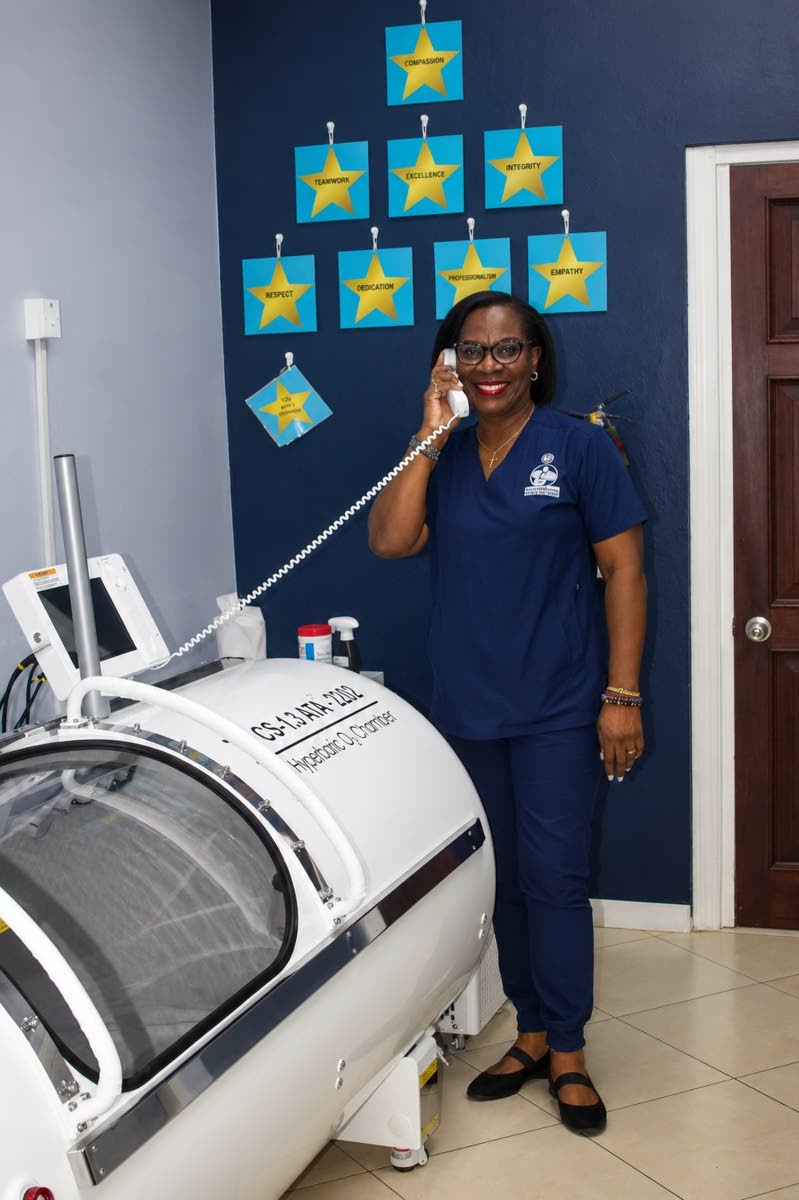 Nurse Jacynth Moore, Intermediate Hyperbaric technician, alongside Bioregeneration’s Hyperbaric Oxygen Chamber, one of the centre’s newest treatment offerings.