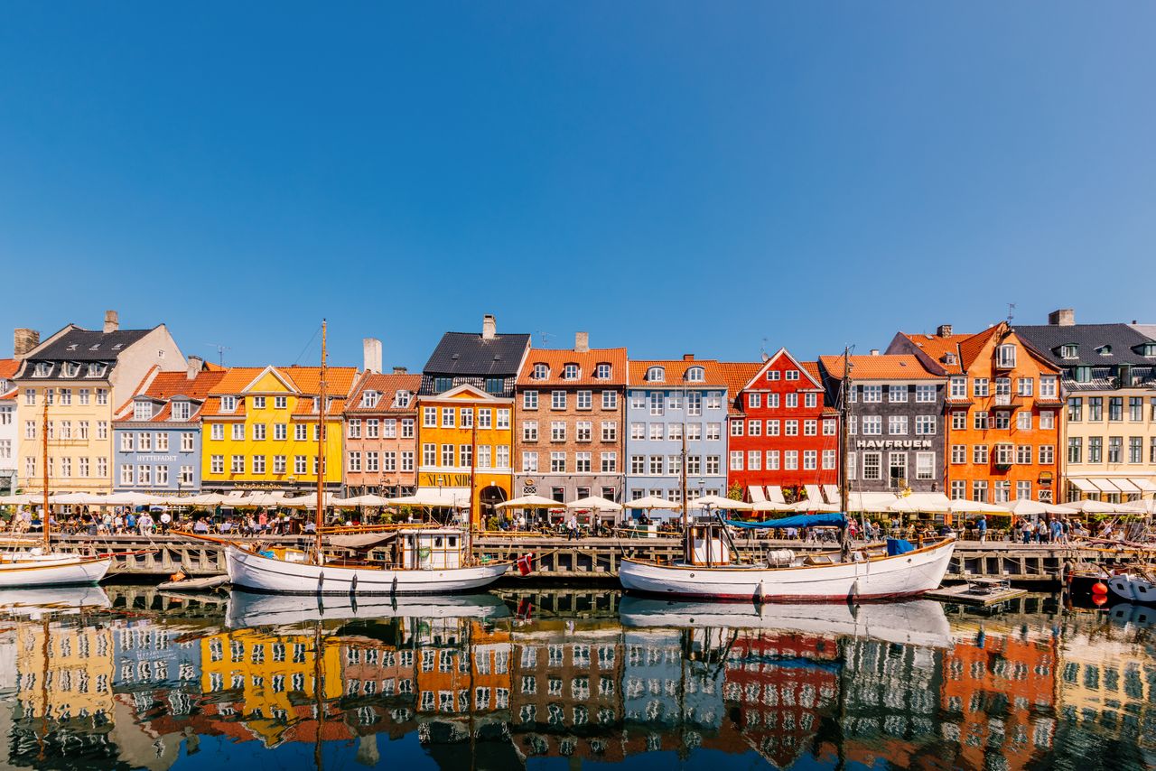 Multi-colored homes line the Nyhavn harbour in Copenhagen, Denmark.Credit: Alexander Spatari / Getty Images