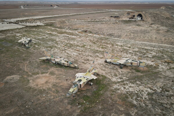 Decommissioned Syrian air force planes are seen at the Abu Duhur military air base east of Idlib, following the takeover of the area by Syrian opposition fighters on Saturday, Dec. 7, 2024. (AP Photo/Omar Albam, File)