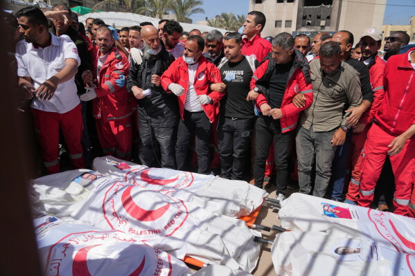 FILE.- Mourners gather around the bodies of 8 Red Crescent emergency responders, recovered in Rafah a week after an Israeli attack, as they are transported for burial from a hospital in Deir al-Balah, Gaza Strip, on Monday, March 31, 2025. (AP Photo/Abdel Kareem Hana,File)