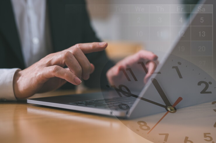 Man typing on laptop, view of clock, employee working a lot