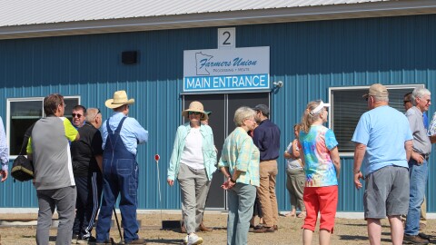 People gather outside the Minnesota Farmers Union's new slaughter and meat processing facility Aug. 18, 2026, in Staples.