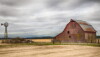 a windmill and an old red barn in a field_Photo by Gary via AdobeStock_238739924.jpeg.jpg