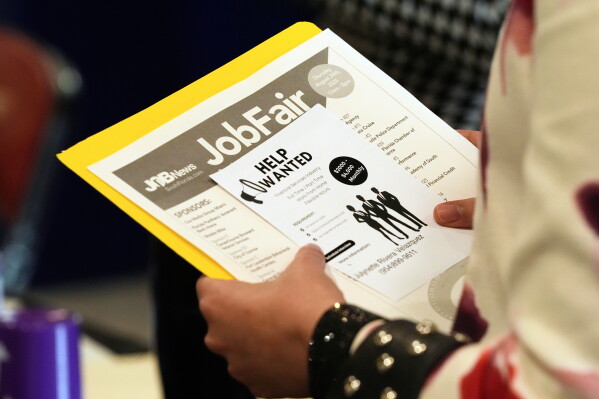 A job seeker waits to talk to a recruiter at a job fair Aug. 28, 2025, in Sunrise, Fla. (AP Photo/Marta Lavandier, File)