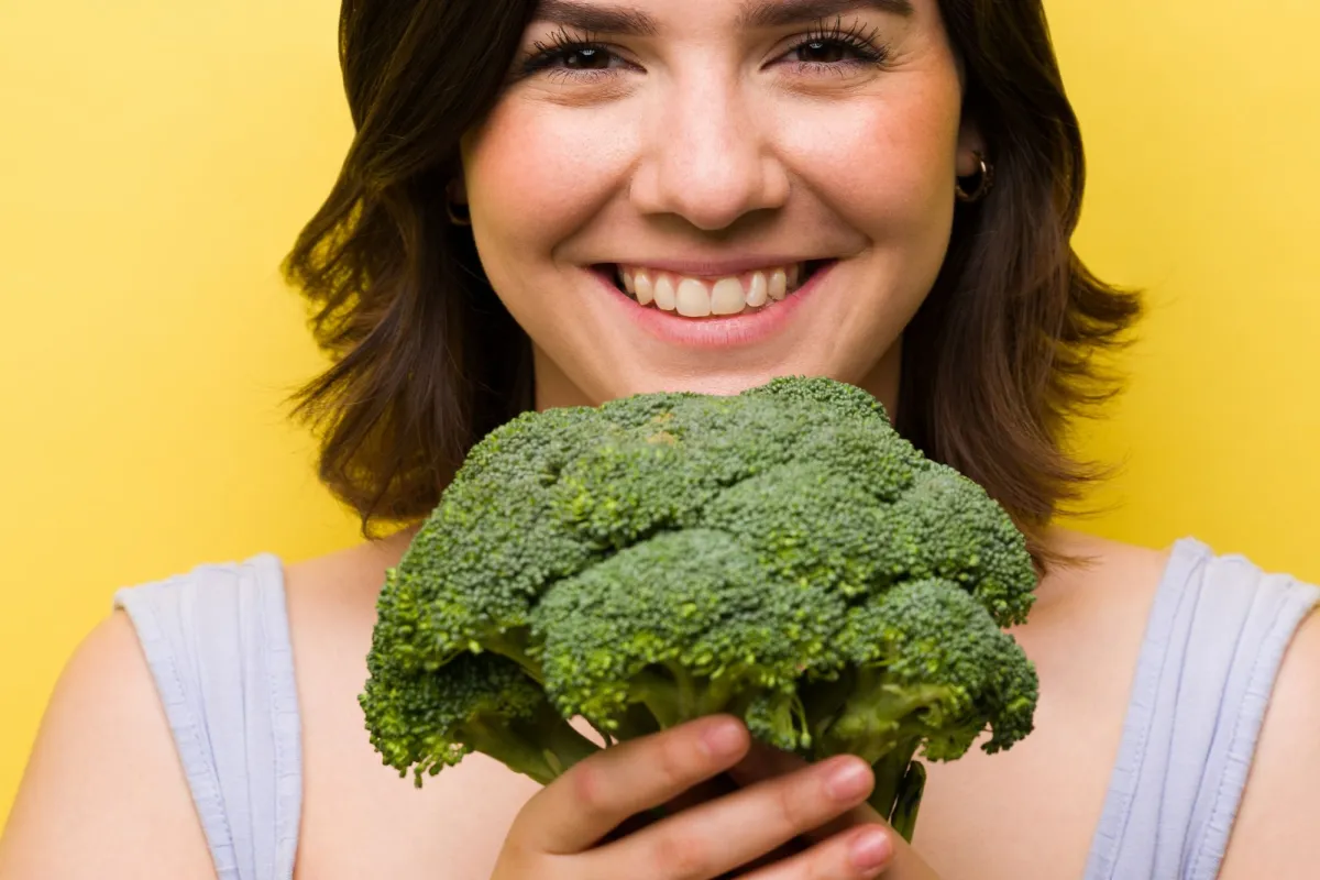 Woman holding a head of broccoli