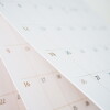 Calendar page flipping sheet close up blur background business schedule planning appointment meeting concept