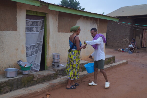 Wiza Bondele, right, a health worker on the prevention and control team, seen at his home in Ituri province, eastern Congo, Wednesday, Aug 5, 2026. (AP Photo/Dieudonne Dirole)