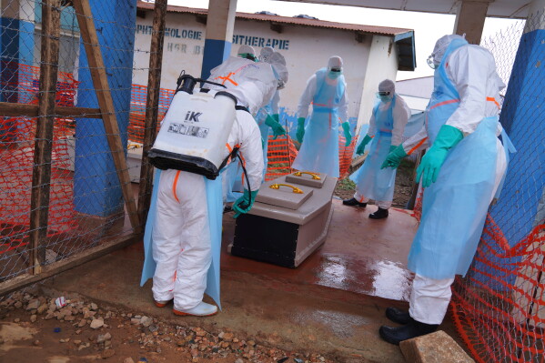 Health workers disinfect a coffin of an Ebola victim at Ebola Treatment Center at Bunia General Hospital in Ituri, Congo, Wednesday, July 22, 2026. (AP Photo/Dirole Lotsima Dieudonne)