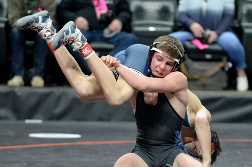 BBE's Tyler Bents hoists up United South Central's Blake Legred during their Class A 138-pound semifinal match at the Xcel Energy Center in St. Paul. Joe Brown / Tribune