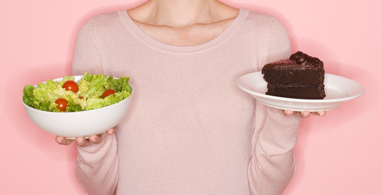Woman holding salad and cake