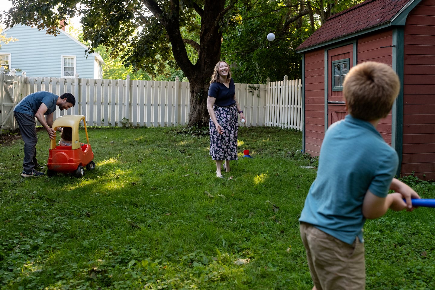 Liz Marnik pitches to her son, Owen, in the yard of her home in Ellsworth, Maine. It was when she became a mother herself that she came to have sympathy for her mother’s choices about vaccination.