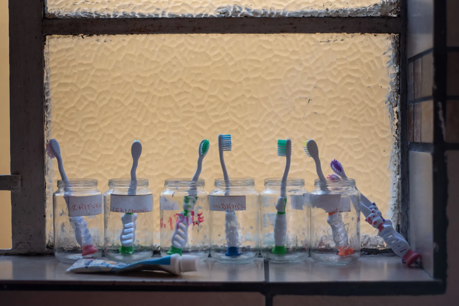 Toothbrushes belonging to abandoned toddlers are displayed next to a window at the Door of Hopes organisation in Hillbrow, Johannesburg, on June 27, 2019.