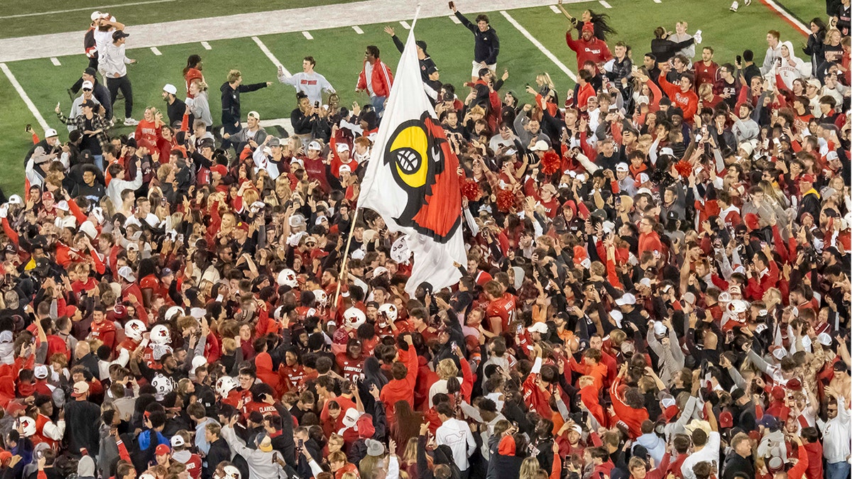 Louisville Cardinals fans storm the field