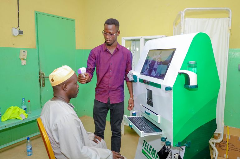 A patient uses a Telemedan kiosk in rural Chad to access healthcare remotely, with the solar-powered facility helping overcome distance and limited medical services