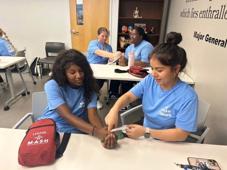 MASH Camp students at Cabot doing a hands-on activity with gauze.