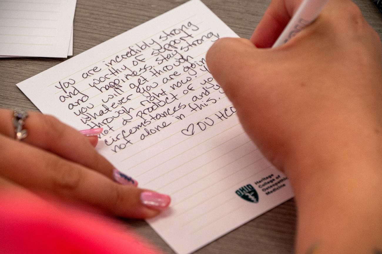 HCOM student writes note to recipient of hygiene kit