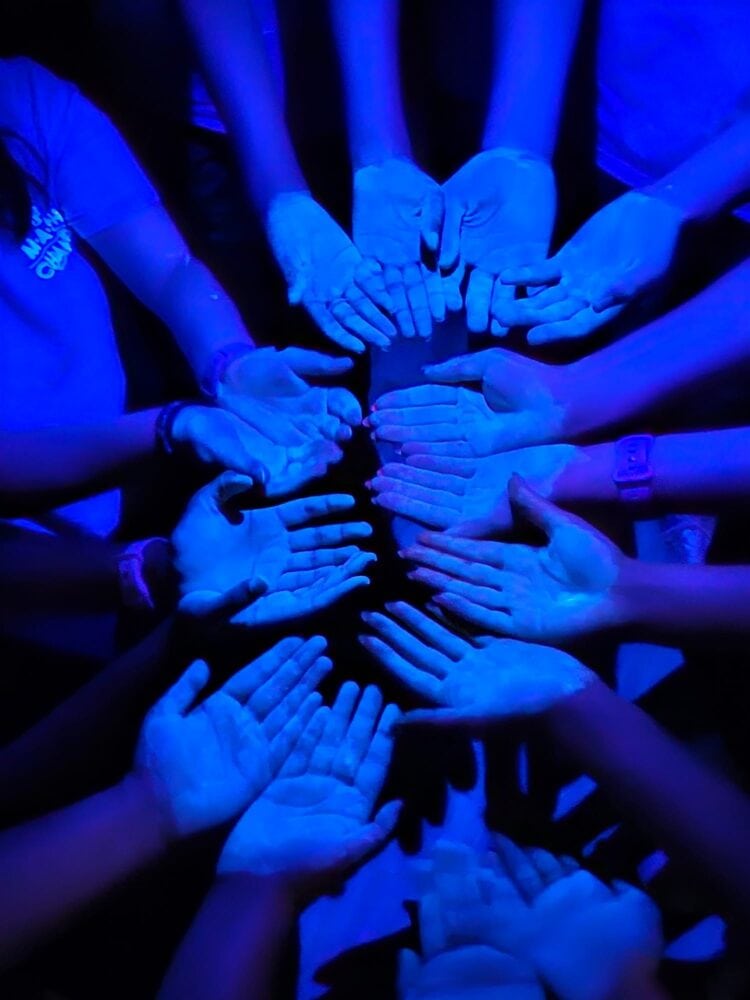 A glowing gel allows students to see hand germs with a black light.