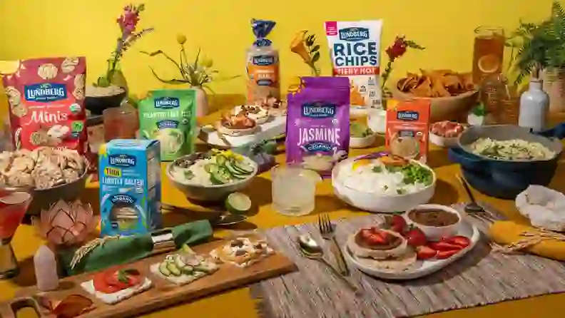 Table spread of Lundberg rice cakes, chips, and rice dishes
