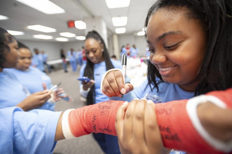 Danijah Patillo from White Hall High School signs a cast.