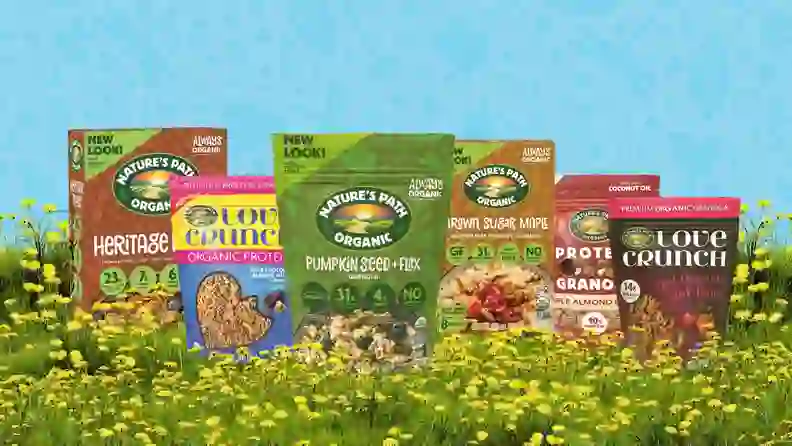 Nature's Path granola and oatmeal packages in a flowering meadow