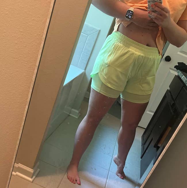 A reviewer wearing the shorts indoors