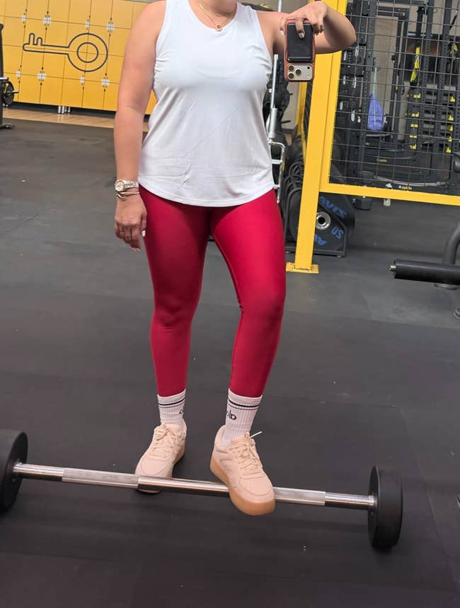 A reviewer wearing the top at the gym