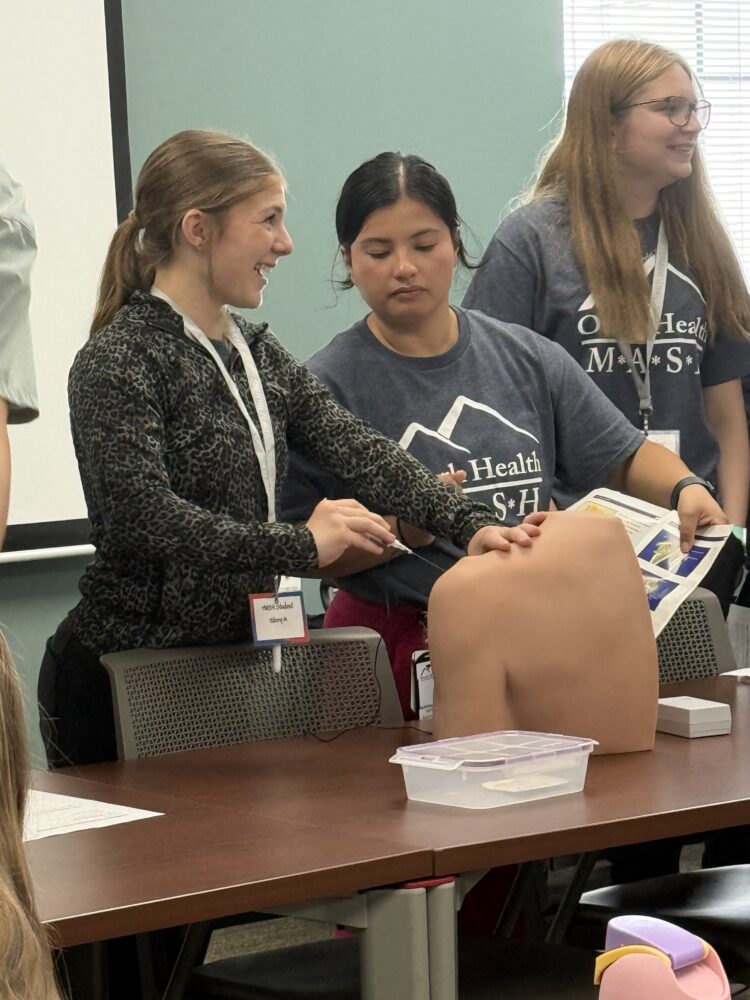 Students do shoulder injections at Clinton's Mini-MASH Camp at Ozark Health Medical Center.