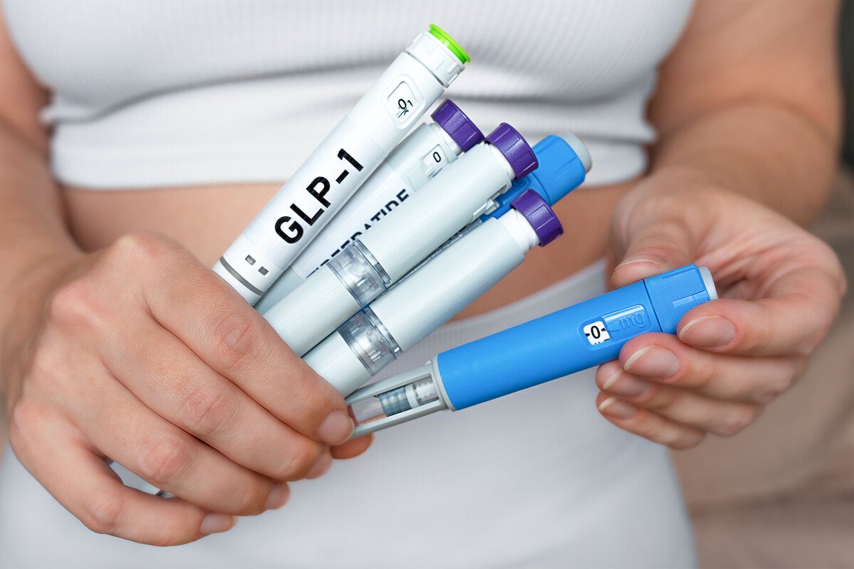 Woman holding multiple GLP-1 injection pens