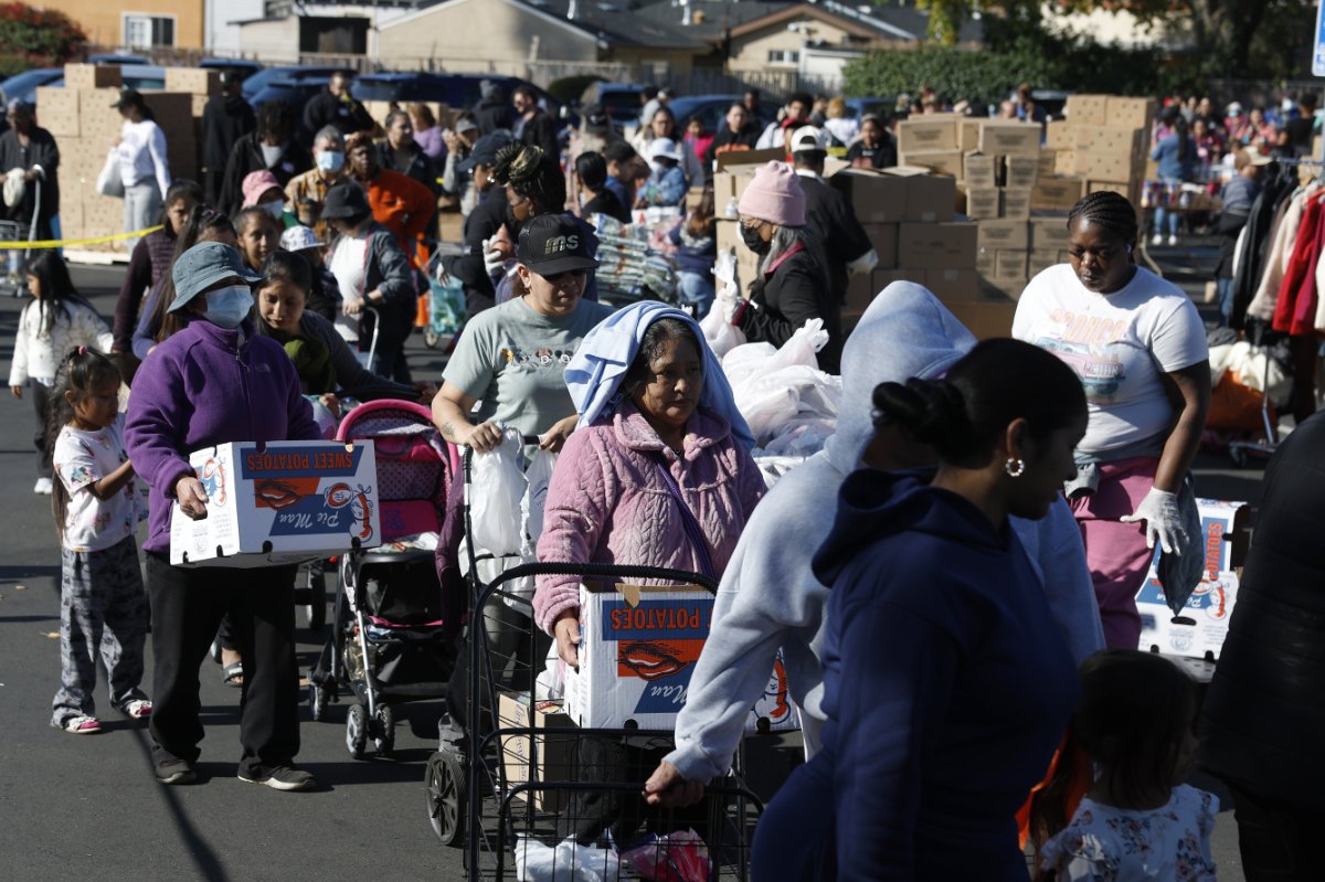 OAKLAND, CALIFORNIA - NOVEMBER 24: People in need line up to receive free food during a Thanksgiving food giveaway at Shiloh Mercy House on November 24, 2025 in Oakland, California. Thousands of people lined up to receive free Thanksgiving meal items during a food giveaway in Oakland, as food banks continue to operate in crisis mode despite the federal government shutdown ending. Tens of thousands of Bay Area households are turning to emergency groceries after the temporary halt in SNAP benefits worsened already high levels of food insecurity. (Photo by Justin Sullivan/Getty Images)