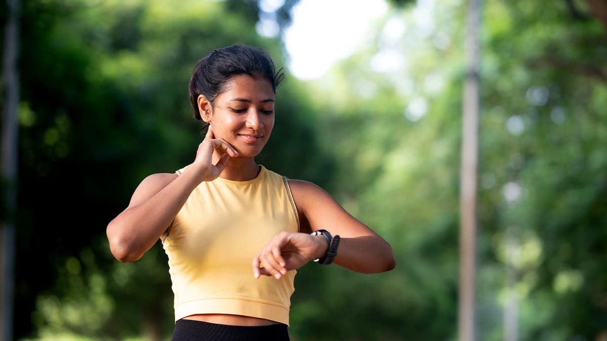 A runner checks her pulse.