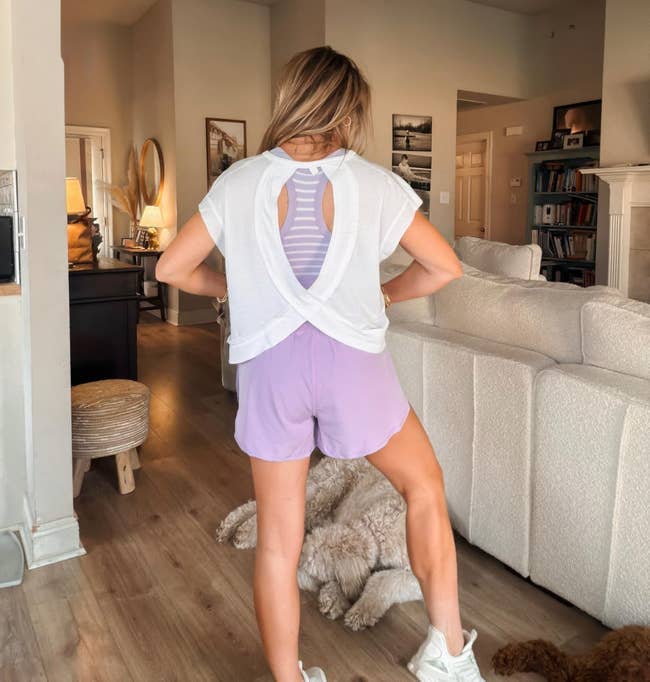 A reviewer showing the backside of the top