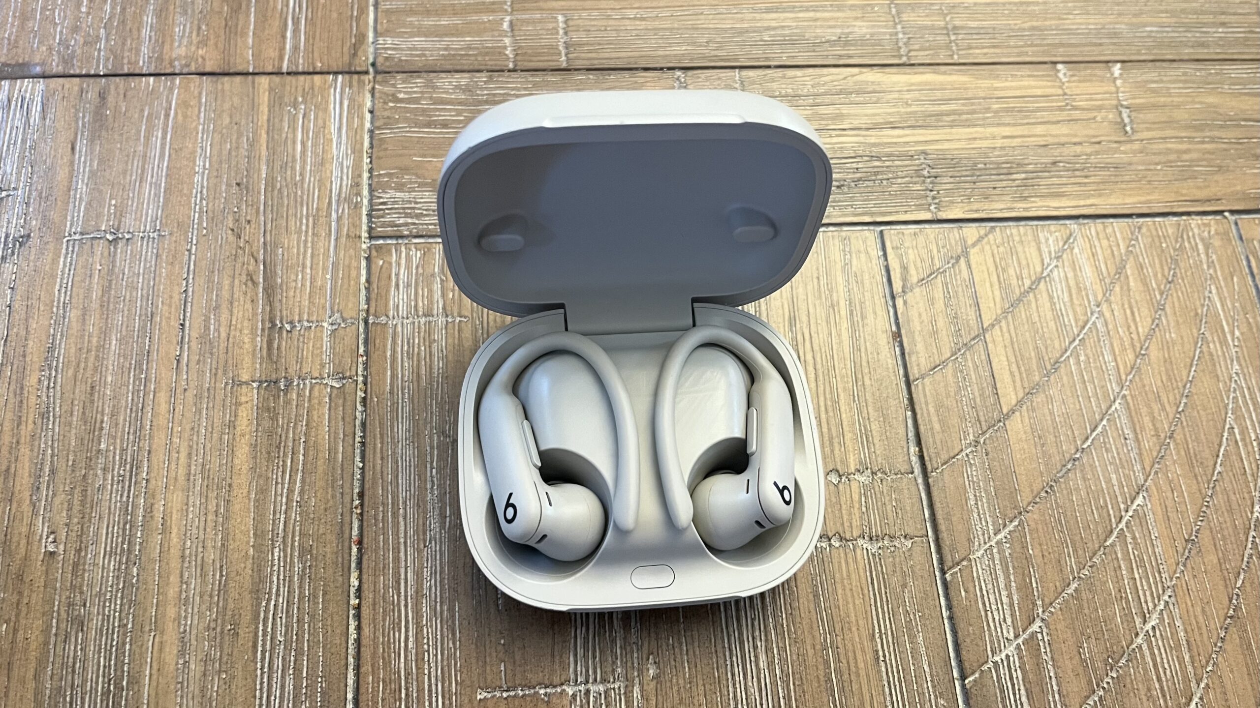 Powerbeat pro 2 in a case on a wooden table