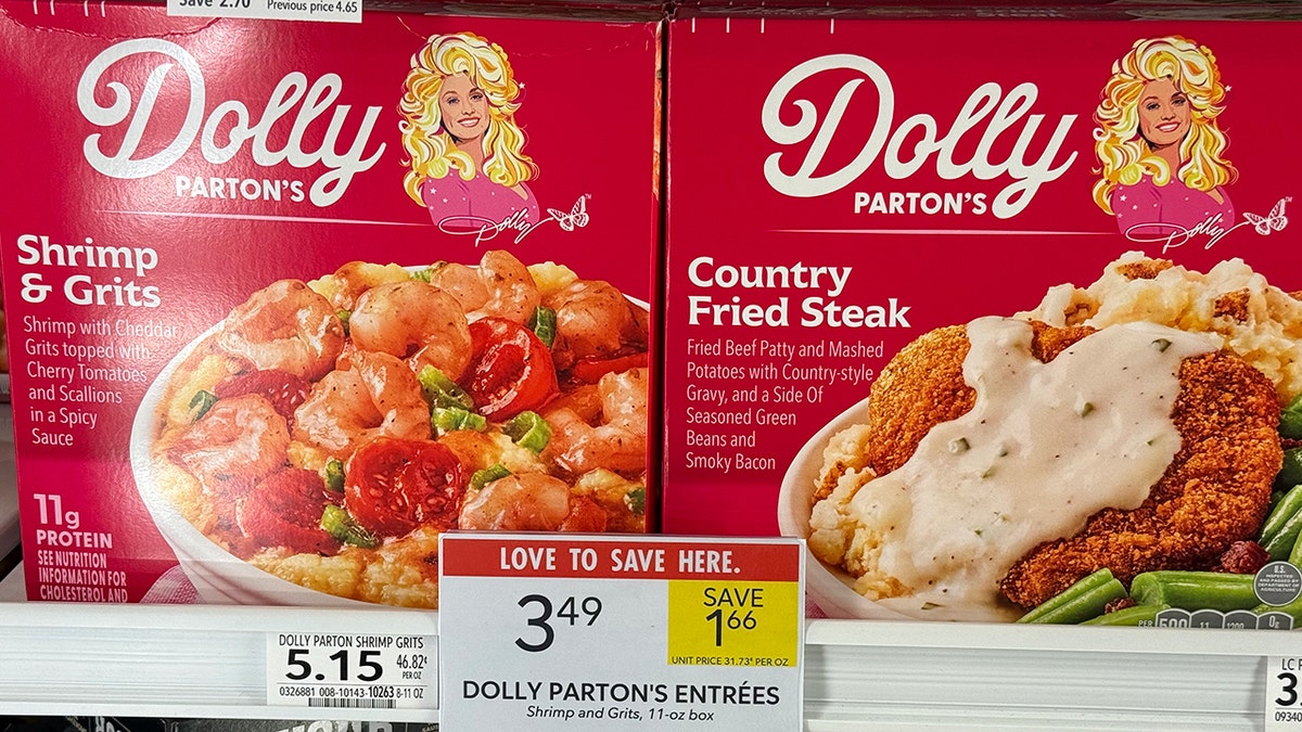 Dolly Parton's Shrimp & Grits and Country Fried Steak TV dinners are shown on a shelf.