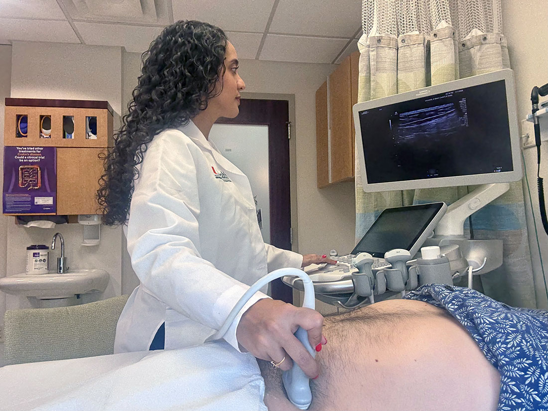 Dr. Stephanie Ioannou, performing an intestinal ultrasound on a male patient in a clinic room